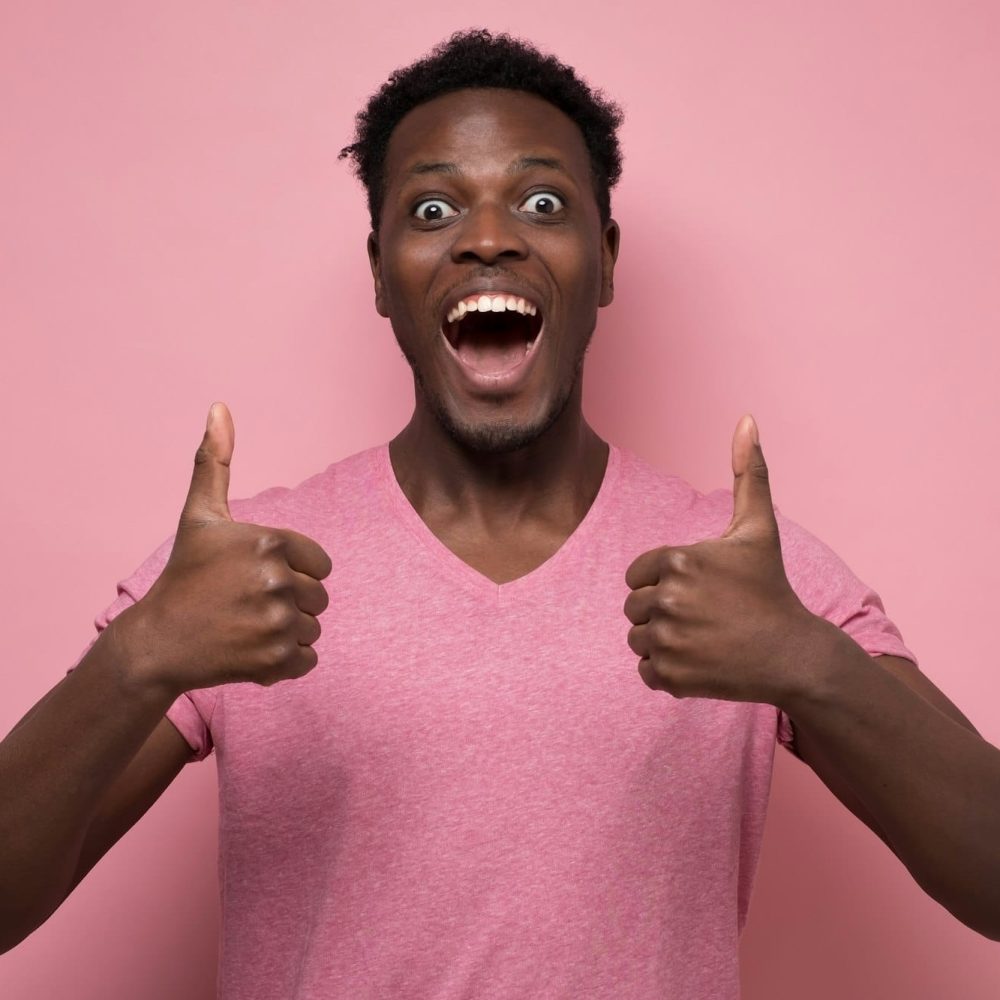 Handsome black man showing thumb up with cheerful attitude